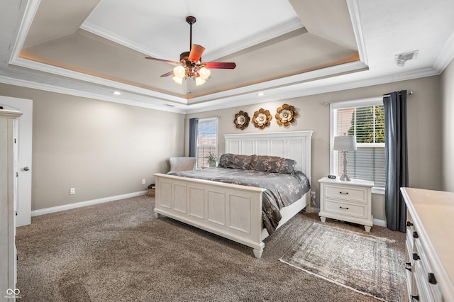 carpeted bedroom featuring multiple windows, a raised ceiling, baseboards, and ornamental molding