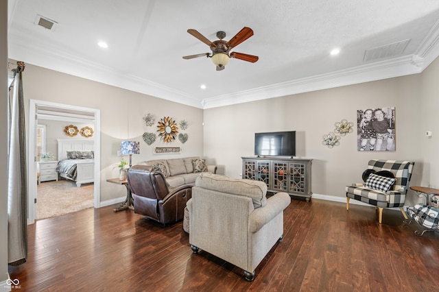 living room with visible vents, a ceiling fan, wood finished floors, crown molding, and baseboards