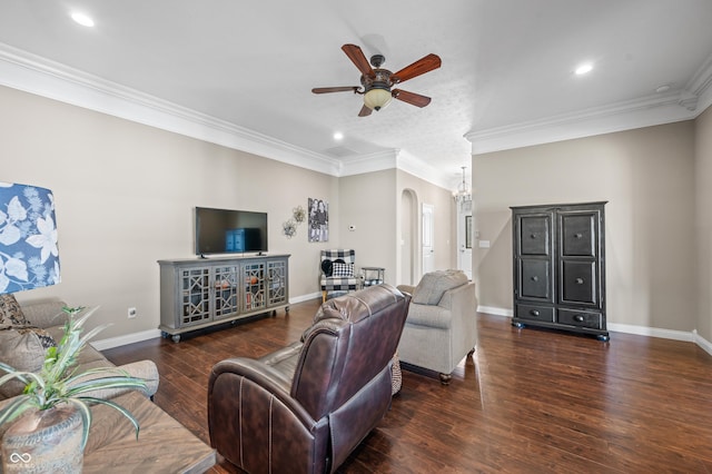 living room featuring a ceiling fan, wood finished floors, arched walkways, crown molding, and baseboards