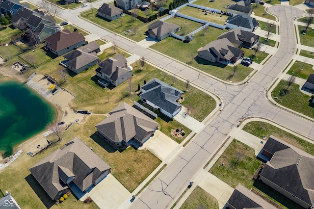 bird's eye view with a residential view and a water view