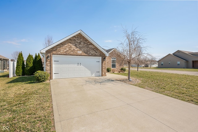 view of home's exterior featuring brick siding, an attached garage, driveway, and a lawn