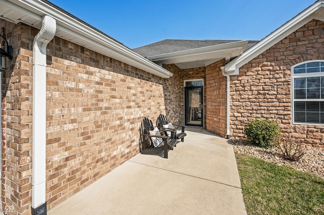 entrance to property featuring brick siding