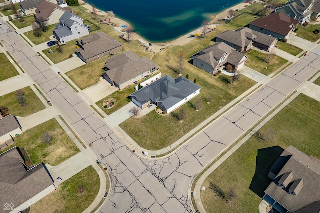 drone / aerial view featuring a residential view and a water view