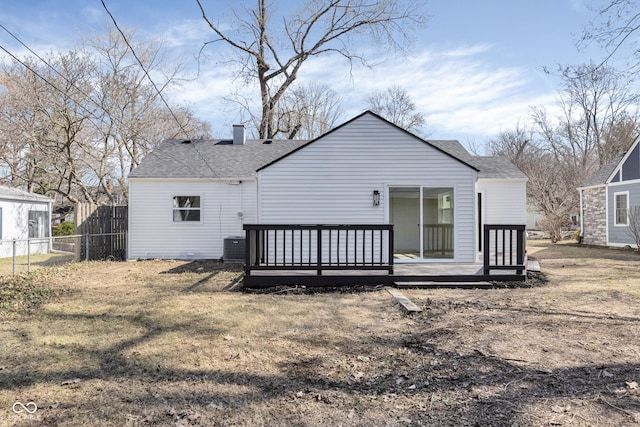 rear view of house with fence, a chimney, roof with shingles, and a wooden deck