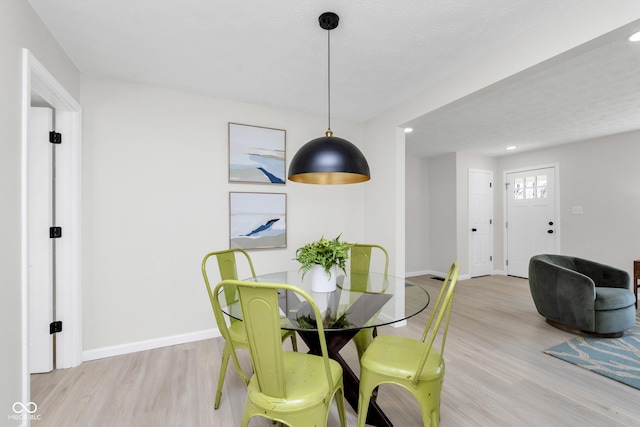 dining room with recessed lighting, wood finished floors, and baseboards