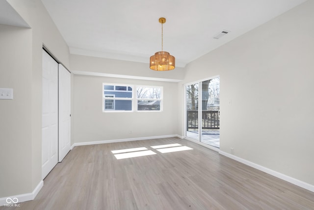 interior space with baseboards, visible vents, and light wood-type flooring