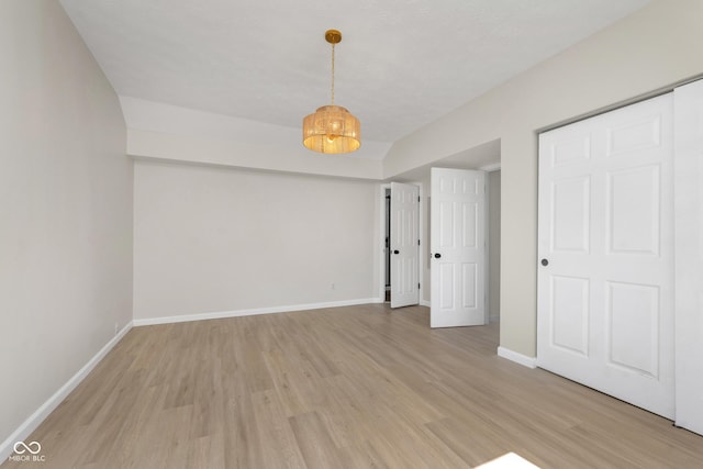 unfurnished bedroom with light wood-type flooring and baseboards