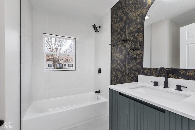 bathroom with vanity, shower / tub combination, and wallpapered walls