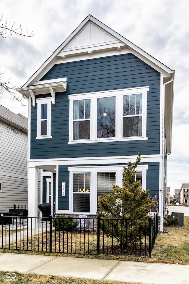 view of front of home featuring a fenced front yard and central AC