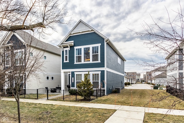 view of front of property featuring a front yard, central AC, board and batten siding, and a fenced front yard