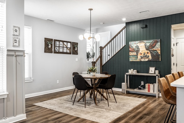 dining room featuring stairway, visible vents, dark wood-style flooring, and baseboards