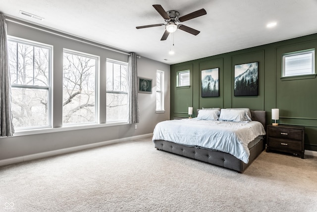 bedroom with visible vents, baseboards, a ceiling fan, and carpet flooring