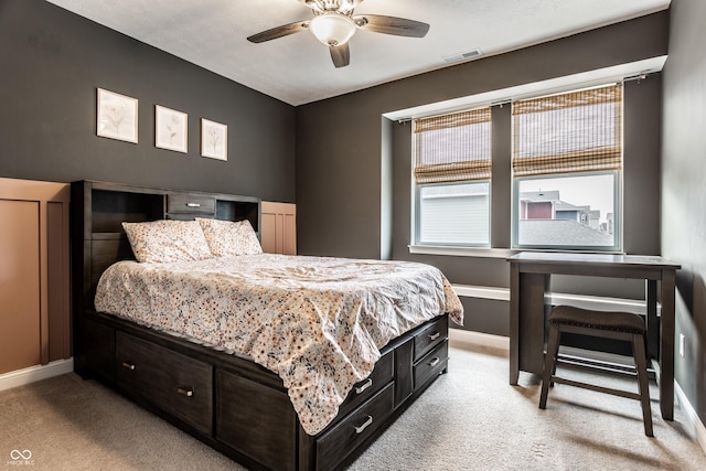 bedroom featuring visible vents, baseboards, light colored carpet, and a ceiling fan