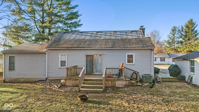 back of property with a deck, crawl space, central AC, and a chimney