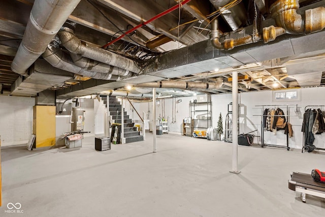 below grade area featuring gas water heater and stairs