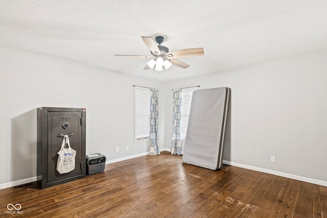 empty room with baseboards, wood-type flooring, and ceiling fan