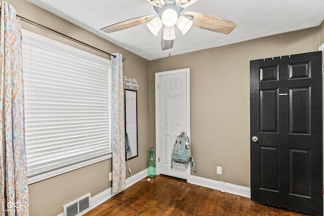 unfurnished bedroom with visible vents, baseboards, wood finished floors, and a ceiling fan