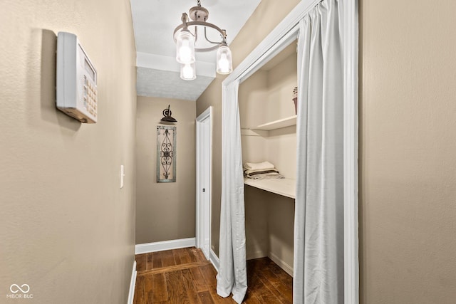 hall with baseboards and dark wood-style floors