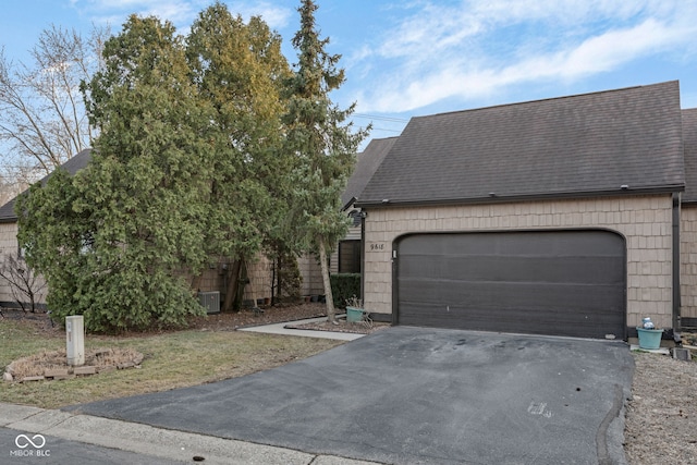 view of front of property with driveway and a shingled roof