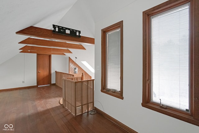 additional living space with lofted ceiling, wood finished floors, and baseboards