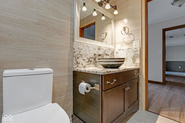 bathroom with vanity, toilet, and baseboards