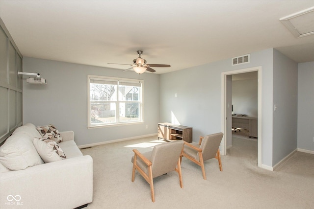 living area featuring ceiling fan, baseboards, visible vents, and light carpet