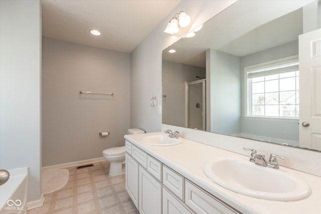 bathroom featuring tile patterned floors, a stall shower, baseboards, and a sink