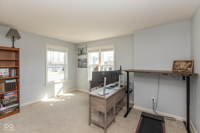 office area featuring light colored carpet and baseboards