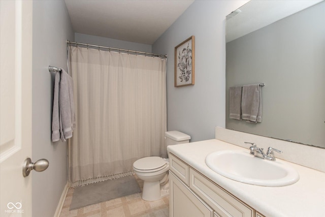 bathroom featuring a shower with shower curtain, toilet, and vanity