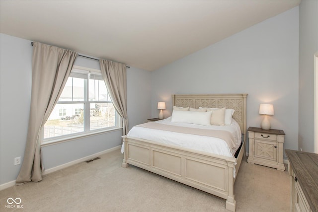 bedroom featuring baseboards, visible vents, lofted ceiling, and light carpet