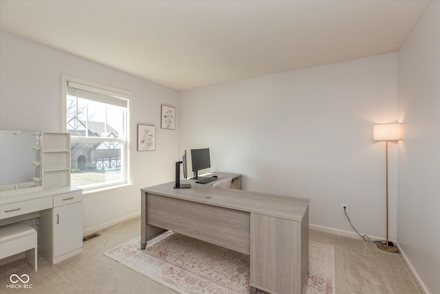 office space featuring visible vents, baseboards, and light colored carpet