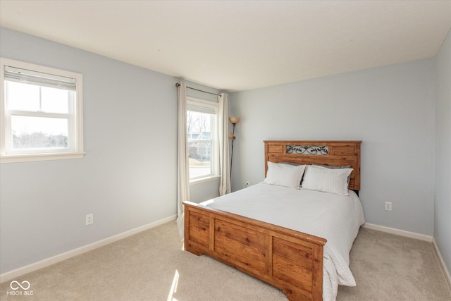 bedroom featuring baseboards and light carpet