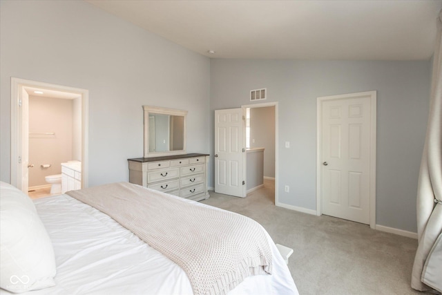 bedroom with baseboards, visible vents, ensuite bath, vaulted ceiling, and light carpet