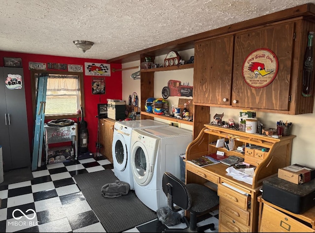 clothes washing area featuring tile patterned floors, laundry area, washer and dryer, and a textured ceiling