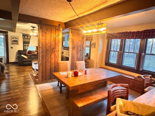 dining space featuring a textured ceiling and wood finished floors