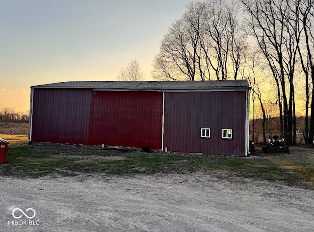 outdoor structure at dusk featuring an outbuilding and an outdoor structure