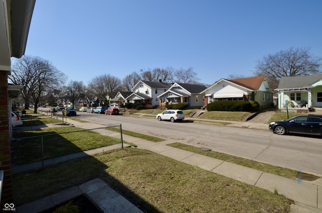 view of street with a residential view, curbs, and sidewalks