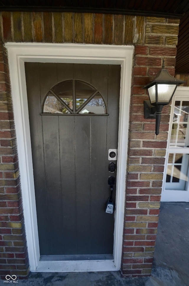 property entrance featuring brick siding