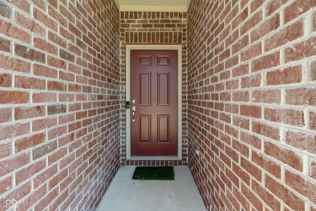 entrance to property with brick siding