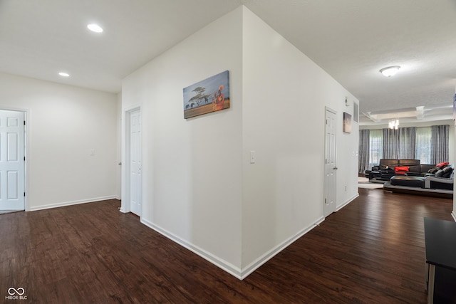 hallway featuring recessed lighting, baseboards, and dark wood-style flooring