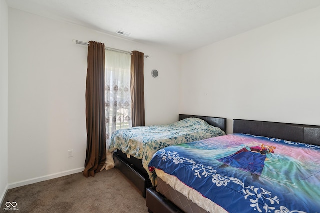 bedroom featuring visible vents, carpet, and baseboards