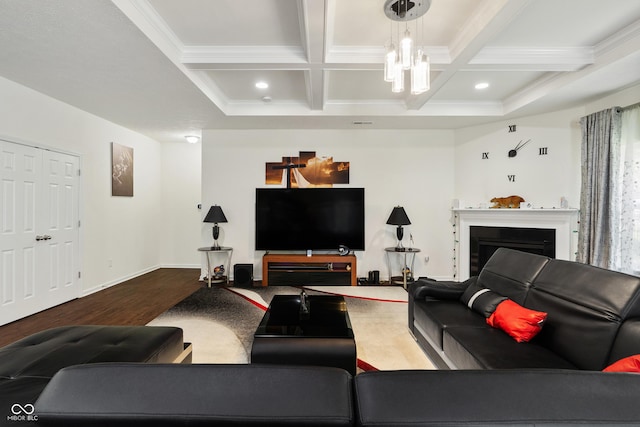 living room featuring a chandelier, beamed ceiling, a fireplace, and coffered ceiling