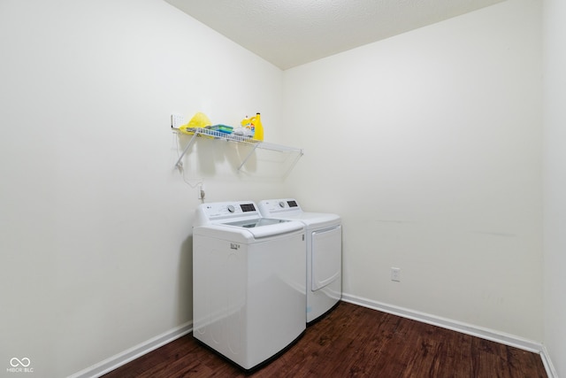 washroom featuring laundry area, independent washer and dryer, baseboards, and dark wood-style flooring