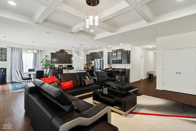 living room with beamed ceiling, an inviting chandelier, and dark wood-style floors