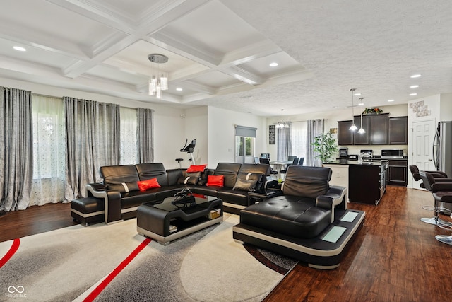 living room with beamed ceiling, a notable chandelier, dark wood-style flooring, and coffered ceiling