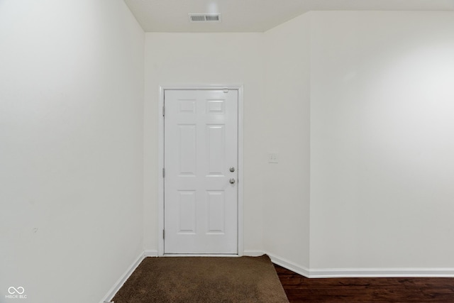 unfurnished room featuring baseboards and visible vents