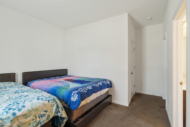 bedroom featuring baseboards and carpet floors