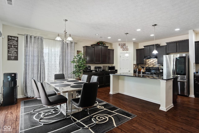 dining room with baseboards, recessed lighting, dark wood-type flooring, a textured ceiling, and a chandelier