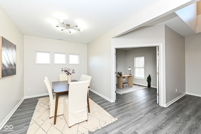 dining area featuring baseboards and wood finished floors