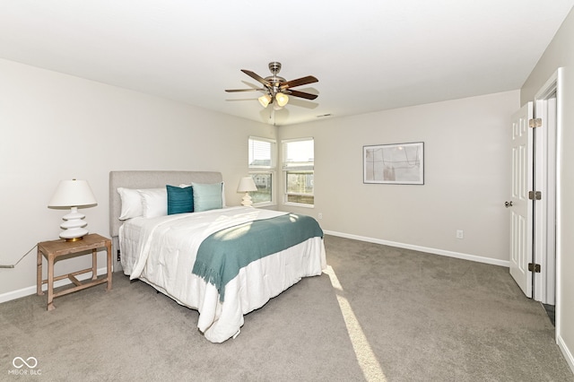 bedroom with visible vents, baseboards, light colored carpet, and a ceiling fan